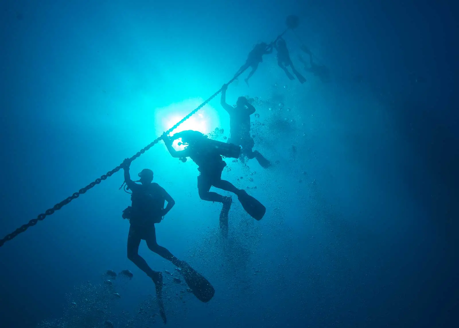 Divers silhouetted on the downline descending to the Texas Clipper